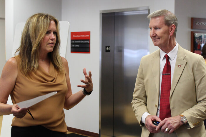 Crane Center Executive Director Dr. Laura Justice, left, talks to Ohio State University President Walter "Ted" Carter.