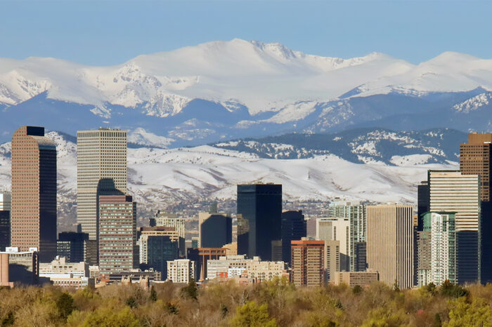 The skyline of Denver, Colorado, set against the backdrop of the Rocky Mountains