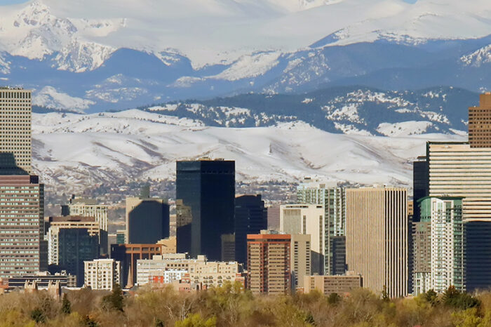 The skyline of Denver, Colorado, set against the backdrop of the Rocky Mountains