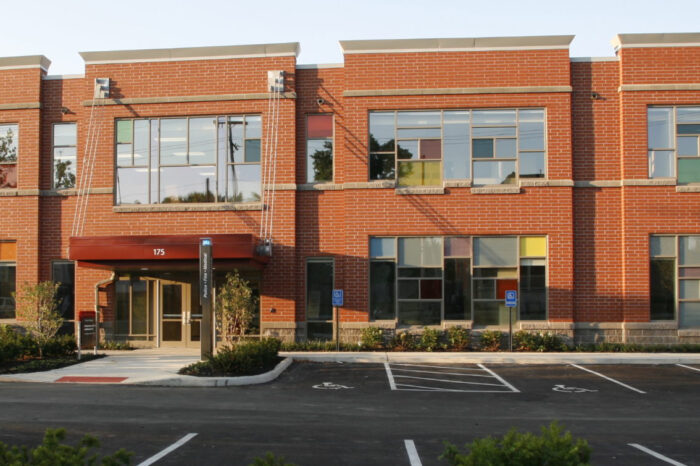 A two-story brick building with large windows is the home of The Ohio State University's Crane Center for Early Childhood Research and Policy and the Schoenbaum Family Center.